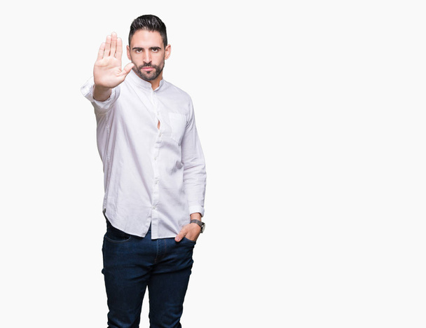 Young business man over isolated background doing stop sing with palm of the hand. Warning expression with negative and serious gesture on the face. - Photo, Image