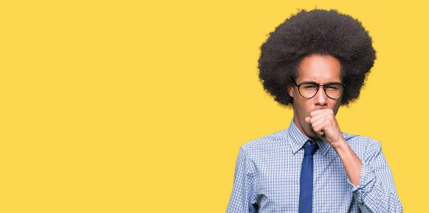 Young african american business man with afro hair wearing glasses feeling unwell and coughing as symptom for cold or bronchitis. Healthcare concept. - Photo, Image