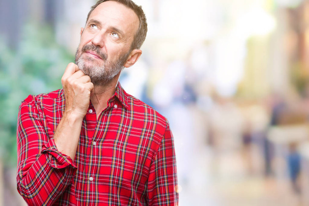 Middle age hoary senior man over isolated background with hand on chin thinking about question, pensive expression. Smiling with thoughtful face. Doubt concept. - Photo, Image