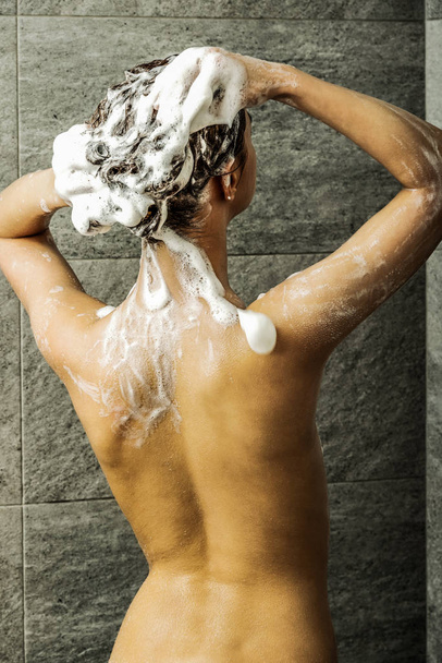 Washing hair, back view - Foto, Imagen