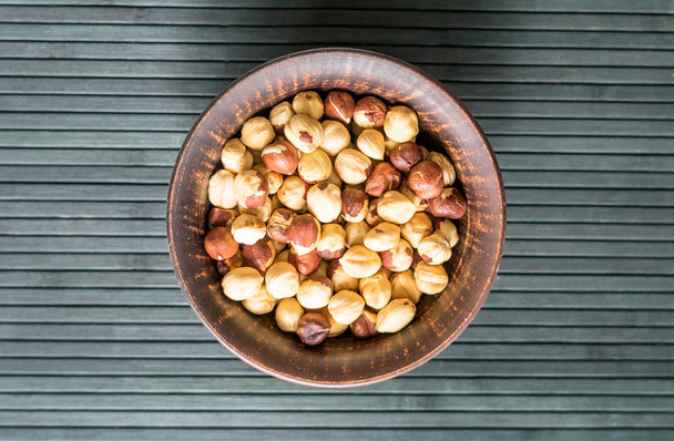 Healthy food  for background image close up hazelnuts.  Nuts texture on top view on the cup plate - Foto, Imagen