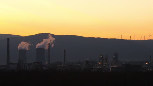 Aerial view of chemical factories in sunset. Energy power stations, chemical factories and wind power stations. Global pollution concept, energy consumption. - Footage, Video