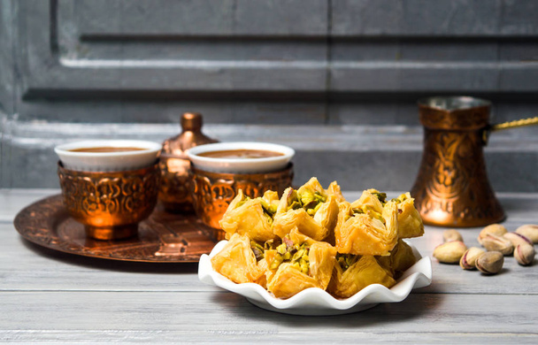 Arabic baklava with coffee in copper cups - Photo, image