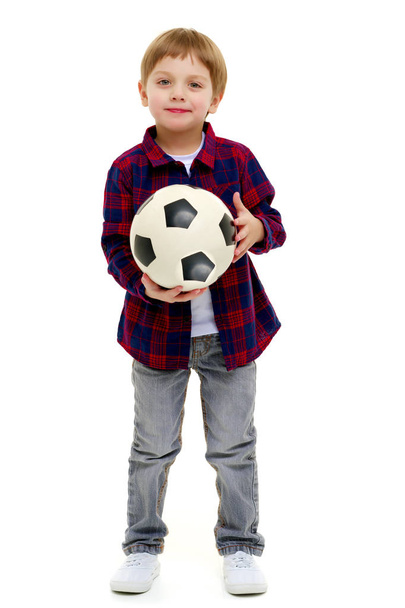 Little boy is playing with a soccer ball. - Foto, imagen