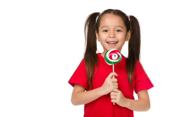 Beautiful cute little girl with a lollipop - Fotografie, Obrázek