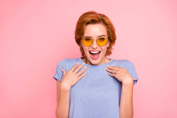 Portrait of her she nice cute charming attractive lovely winsome fascinating cheerful cheery stunned girl wearing casual blue t-shirt yellow glasses isolated over pink background - Zdjęcie, obraz