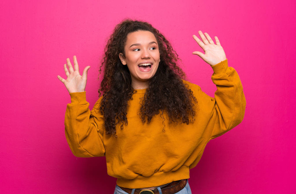 Teenager girl over pink wall counting ten with fingers - Foto, Bild