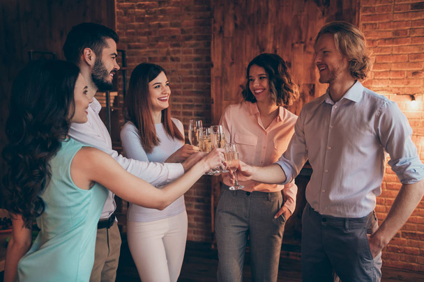 Company of nice elegant classy attractive cheerful positive guys ladies having fun clinking glasses yes goal achievement casual formal-wear in industrial loft interior room indoors - 写真・画像