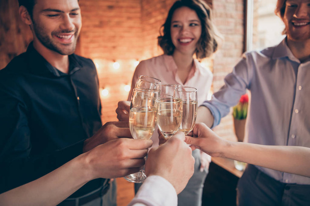 Cropped close-up wineglasses sparkles nice lovely attractive pretty elegant cheerful cheery positive guys ladies having fun greetings birthday festal lights in industrial loft interior room indoors - Foto, Imagem