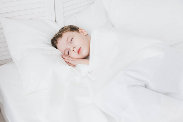 Cute boy sleeps in the morning in bed  - Φωτογραφία, εικόνα