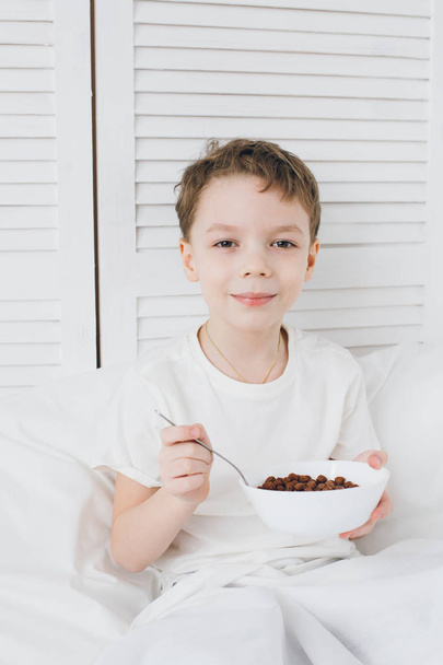 Boy eating Breakfast chocolate balls  - Foto, Imagen
