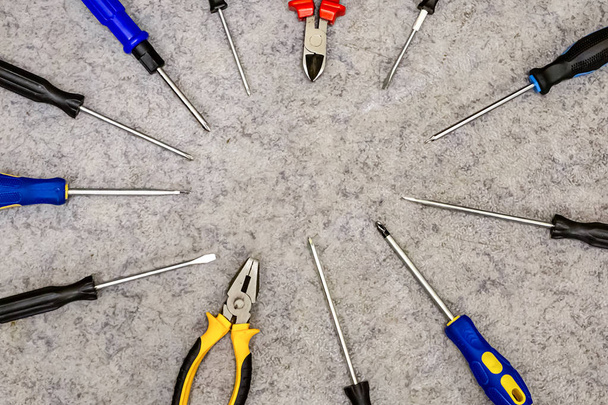 design engineering background long screwdrivers spread out in a circle pliers yellow base repair assembly - Photo, Image