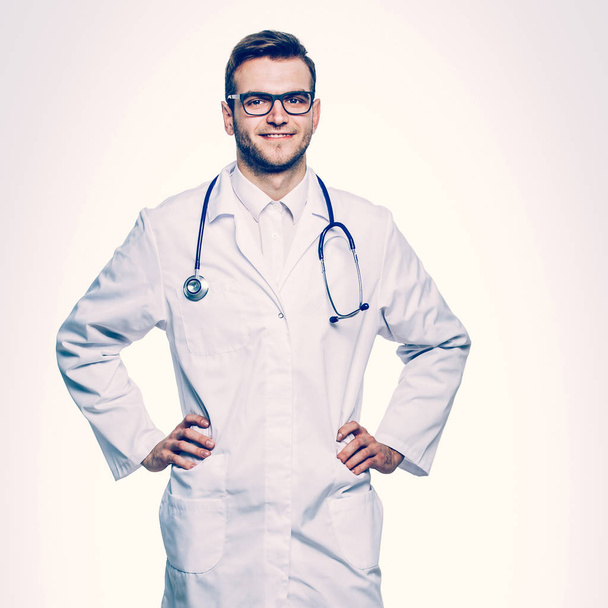 portrait - a family doctor with stethoscope on white background - Fotó, kép