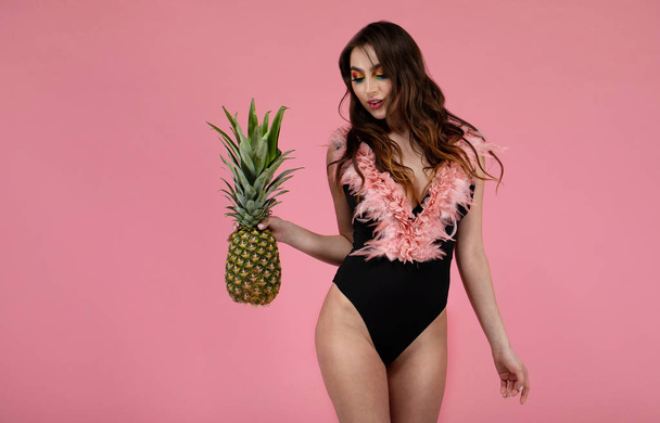 Sexy girl with big boobs in a  swimsuit with a pineapple - Fotó, kép