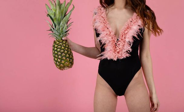 Sexy girl with big boobs in a  swimsuit with a pineapple - Foto, immagini