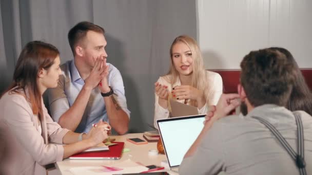 Woman is talking idea inside company of her colleagues in meeting in office - Footage, Video