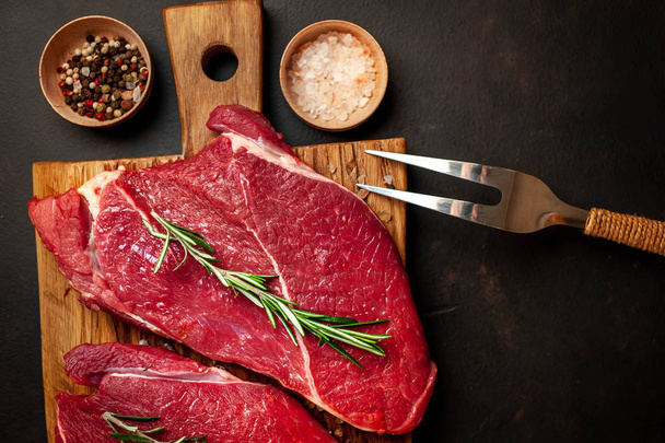 steak, beef, background, board, raw, red, black, food, fresh, view, tasty, wooden, table, ingredient, cooking, cut, lunch, cuisine, juicy, meat, cook, pepper, grill, salt, barbecue, rosemary, greens, average, new, dark, york, stone, ingredients - Photo, image
