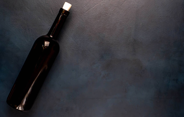 A bottle of wine on a concrete background. Top view with copy space. - Photo, Image