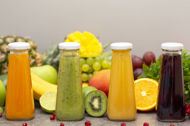 Assortment of fruit and vegetables smoothies in glass bottles. Fresh organic Smoothie ingredients. Detox, dieting or healthy food concept. Vegetarian food. - Fotó, kép