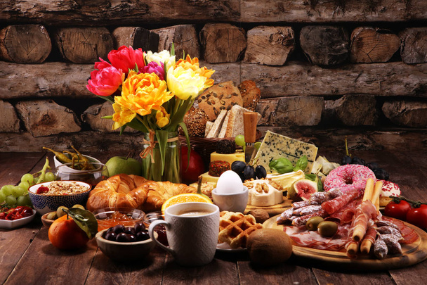 breakfast on table with bread buns, croissants, coffe and eggs - Foto, Imagen