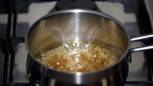 Caramel cooking saucepan on the kitchen. - Footage, Video