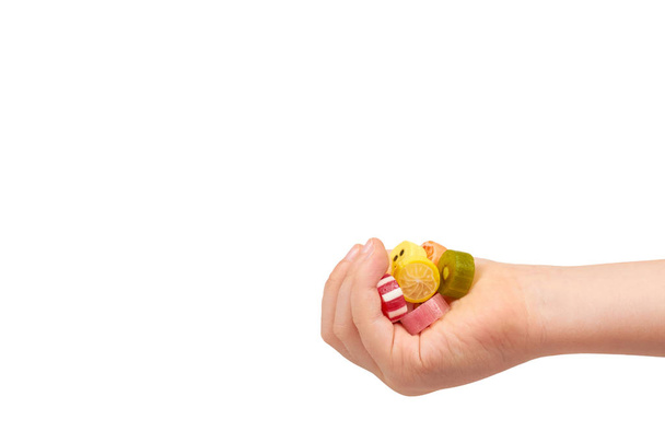 Kids hand with colored round candy, sugar lollipop - Photo, image