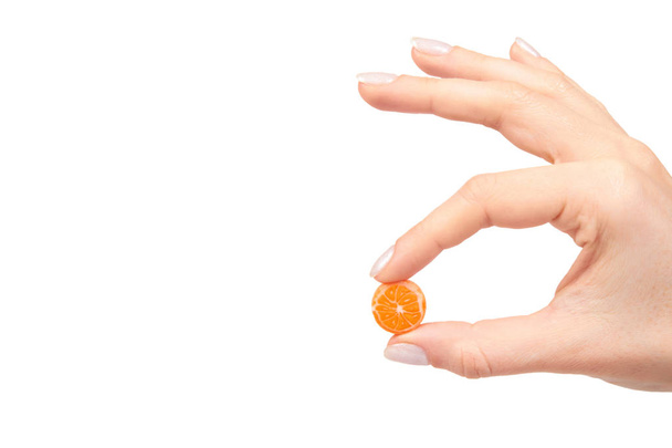 Hand with colored round candy, sugar lollipop - Фото, зображення