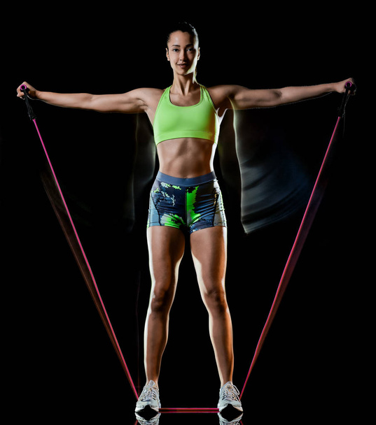 woman exercising fitness exercises isolated black background lightpainting effect - Foto, Imagen