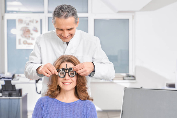 Ophthalmologist using test glasses for vision checking. - Fotó, kép