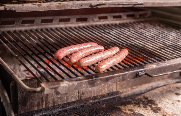 food, delicious and meat concept - roasting horse meat sausages grilled. - Fotografie, Obrázek
