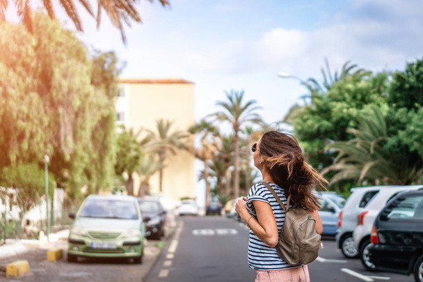 Pretty long hair tourist girl walking on the street. - Fotó, kép