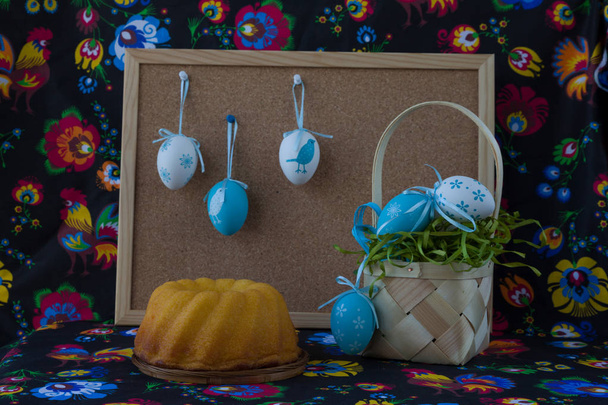 Decoración de Pascua con huevos blancos y azules sobre fondo textil pintado con corcho
.  - Foto, Imagen