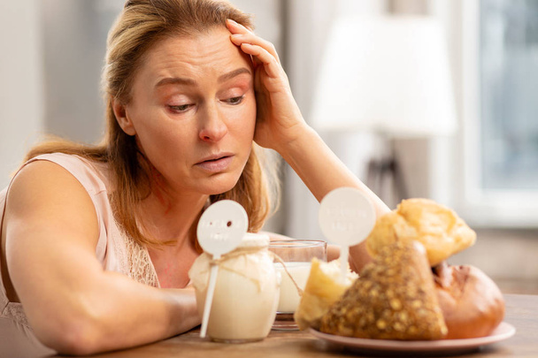 Blond-haired woman having allergy to gluten and dairy - 写真・画像