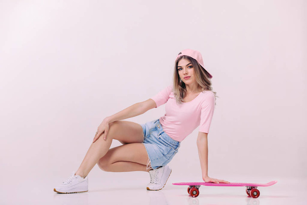 beautiful woman in white t-shirt with pink skateboard - Foto, Imagem