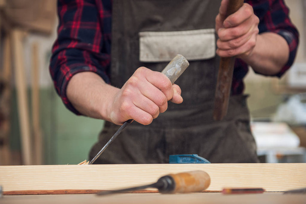 Carpenter working with a chisel - Фото, изображение