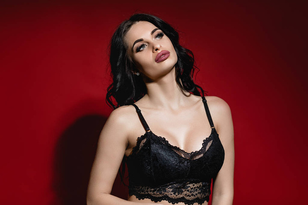 Sexy woman in lace black sensual lingerie with long curly hair - Fotografie, Obrázek