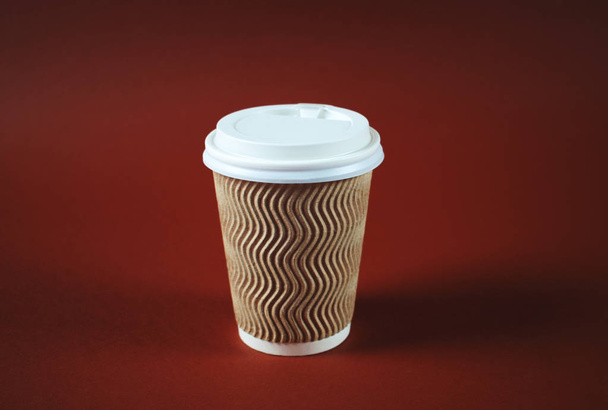 Paper coffee cup on brown background. - Photo, Image