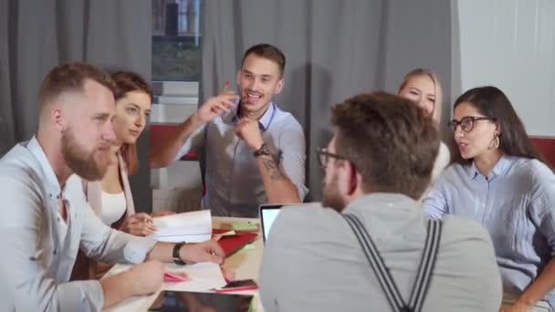 Group of co-workers is meeting in office, chatting cheerfully - Footage, Video