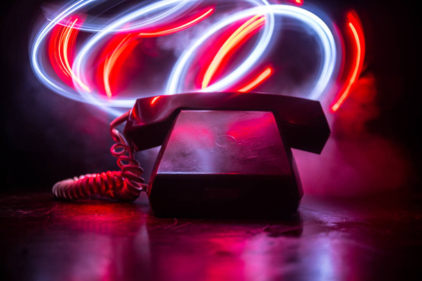 vecchio telefono nero su vecchia tavola di legno con sfondo scuro arte con nebbia e luce tonica. spazio vuoto. Focus selettivo
 - Foto, immagini