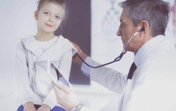 Girl and doctor with stethoscope listening to heartbeat - Foto, Bild