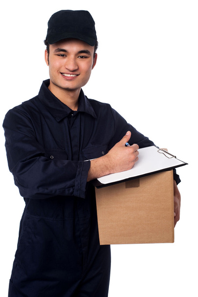 Smiling delivery man at your doorstep - Photo, Image