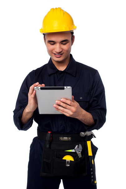 Field worker accessing touch pad - Foto, Imagen