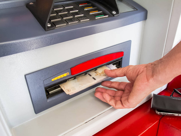 Bliska człowieka wypłaty gotówki z bankomatu - Zdjęcie, obraz
