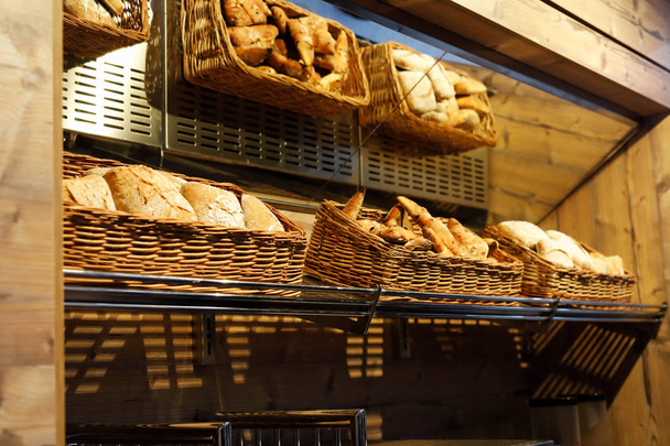 baskets with different types of bread on the shelf - Photo, image