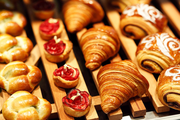 freshly baked pastry on display in bakery shop - Photo, Image