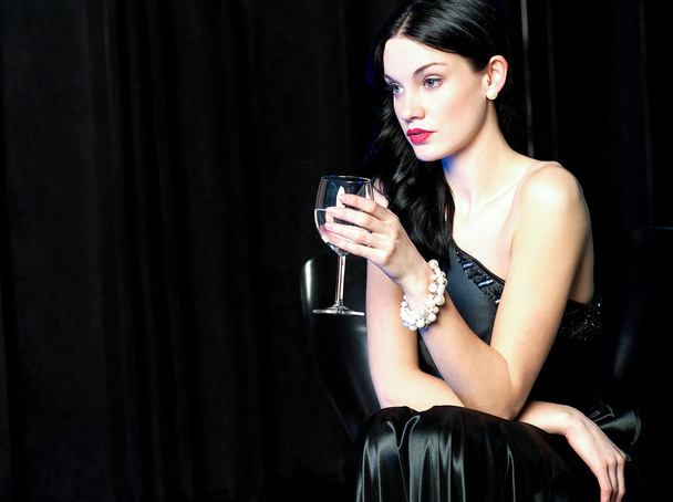 Pretty lady lost in her world, holding wine glass - Zdjęcie, obraz