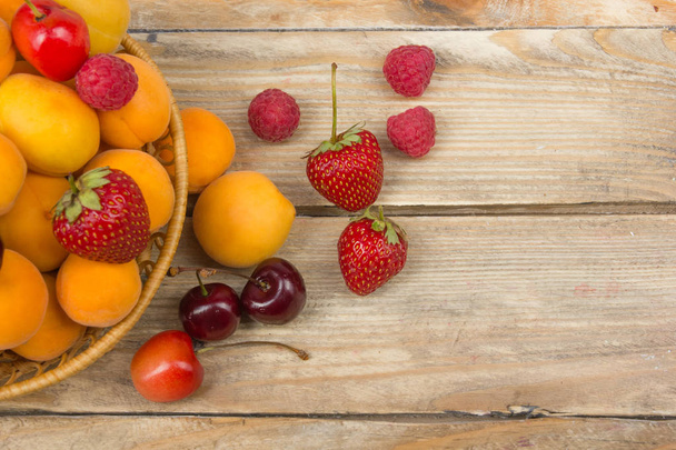Various summer Fresh berries in a bowl on rustic wooden table. .Antioxidants, detox diet, organic fruits - 写真・画像
