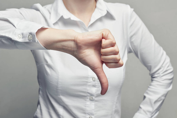 Business woman in blouse showgesture thumb down - Photo, image
