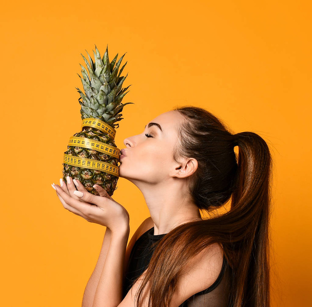 Sporty woman waist with measure tape and pineapple - Zdjęcie, obraz