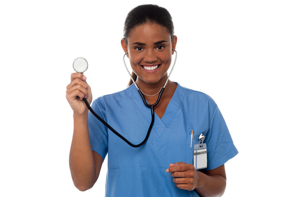 Female physician posing with stethoscope - Foto, Imagen
